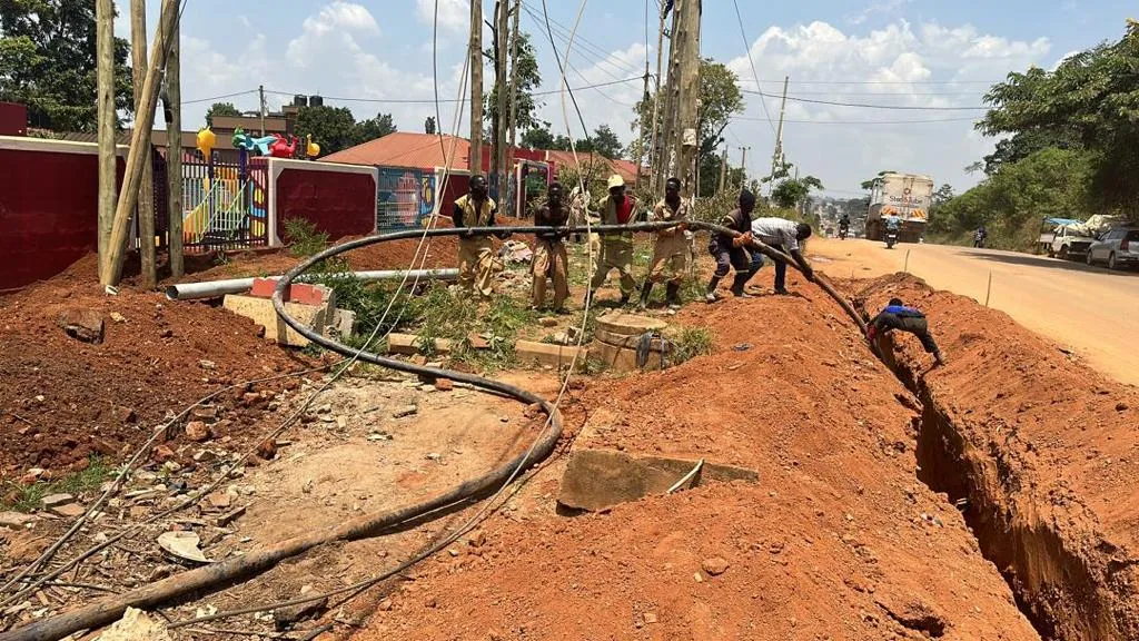 PKAAS technicians installing underground cable in a trench